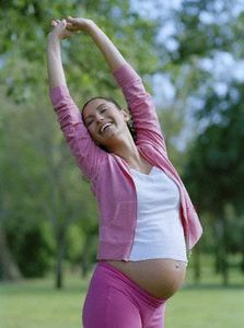Pregnant Woman Stretching in Park