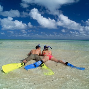 Couple Wearing Flippers Lying on Beach